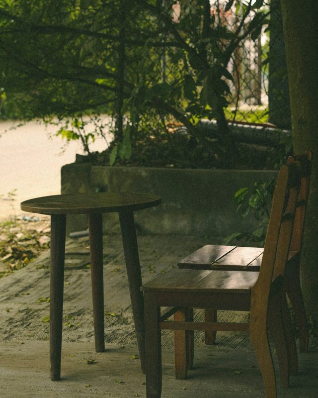 Wooden chairs and table in a tranquil outdoor setting